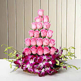 Cane Basket arrangement of 20 pink roses and 6 purple orchids