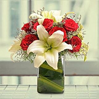 Roses N Lilies - Glass vase arrangement of 10 red roses with 2 white lilies.